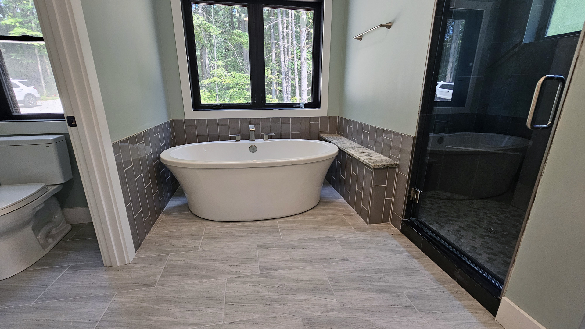 Freestanding tub and custom shower in the Baird House primary bathroom